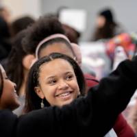 Girls of Color Summit previous event and students taking a selfie at the event